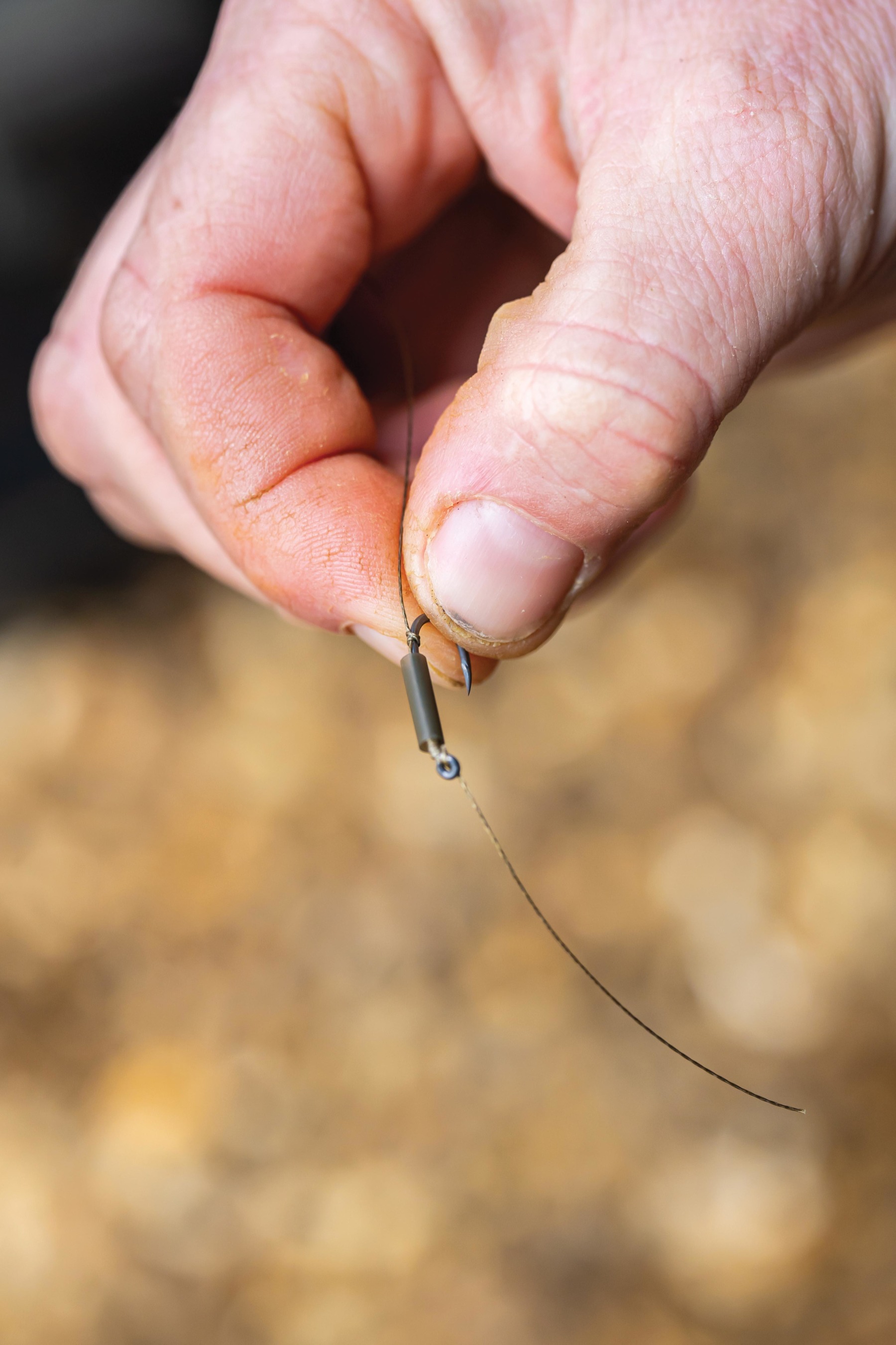 Take a piece of medium shrink tube and slide it over the hook.