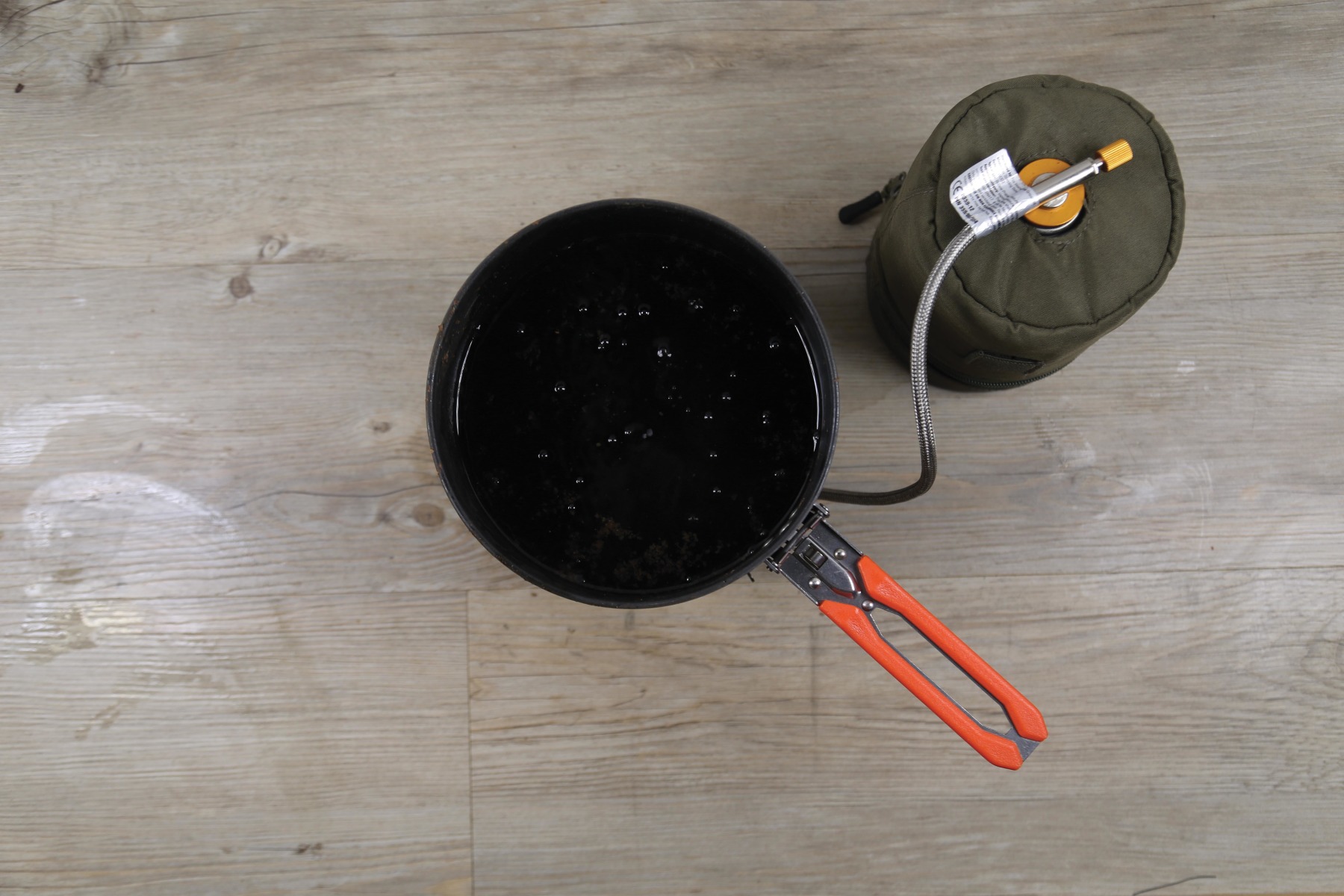 5. Drain off, and then add the Coke liquor to the saucepan, and warm.